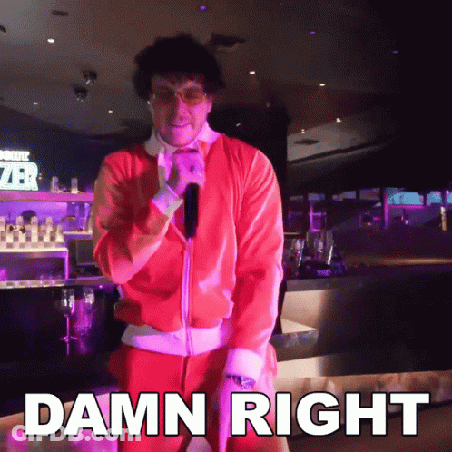 A Man In A Santa Suit Is Standing In Front Of A Sign That Says " Damn Right " GIF