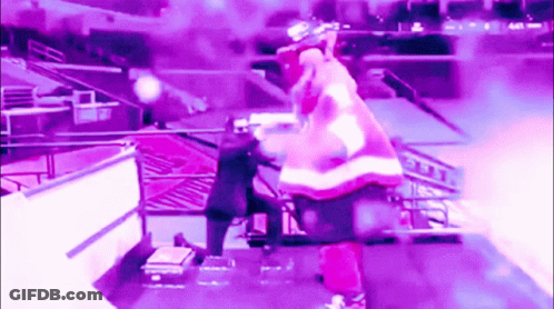 A Man In A Santa Suit Is Standing On A Stage GIF