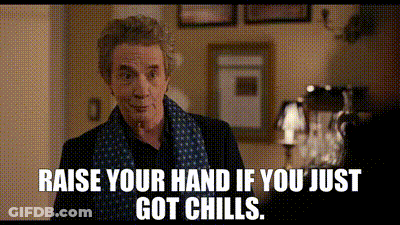 A Man In A Scarf Is Standing In A Room With The Words `` Raise Your Hand If You Just Got Chills '' . GIF