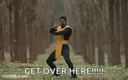 A Man In A Scorpion Costume Is Holding A Sword In A Forest And Says `` Get Over Here '' . GIF