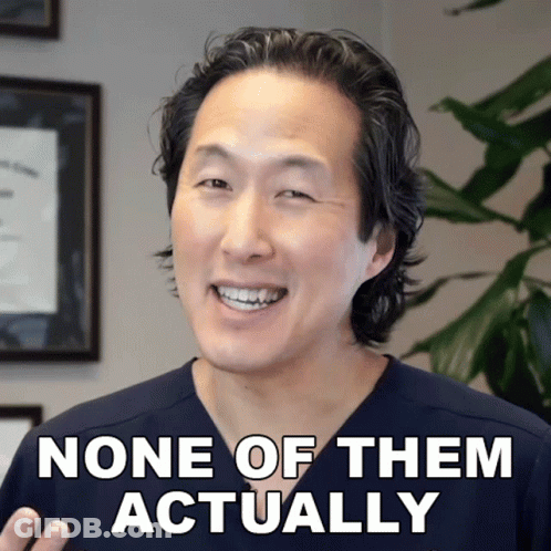 A Man In A Scrub Top Smiles With The Words None Of Them Actually Below Him GIF