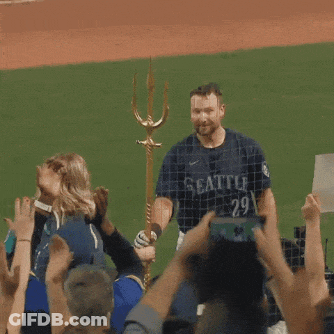 A Man In A Seattle Jersey Stands In Front Of A Crowd GIF