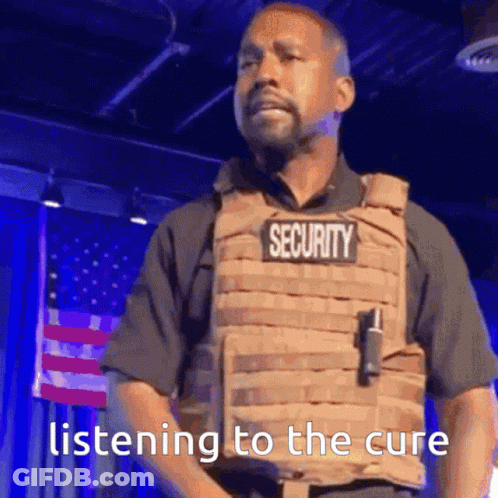 A Man In A Security Vest Is Listening To The Cure . GIF