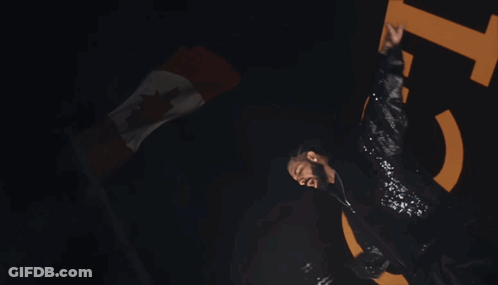 A Man In A Sequined Jacket Is Dancing In Front Of A Large Number 15 GIF