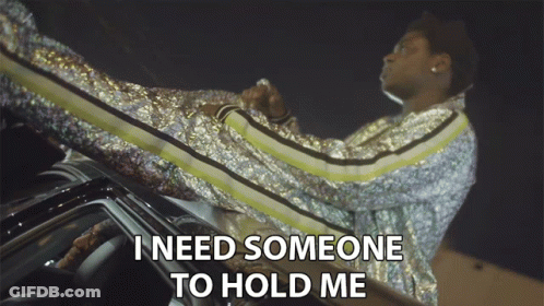 A Man In A Sequined Jacket Sits On The Roof Of A Car And Says I Need Someone To Hold Me GIF