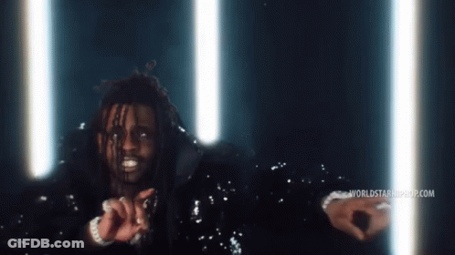 A Man In A Sequined Jacket Stands In Front Of A Worldstarhiphop.com Banner GIF