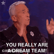 A Man In A Sequined Suit Is Saying You Really Are A Dream Team . GIF