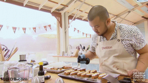 A Man In A Sheldon Apron Is Cooking GIF