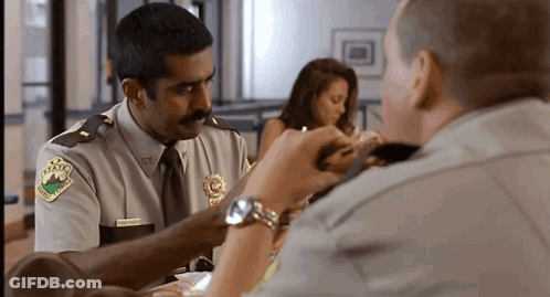 A Man In A Sheriff 'S Uniform Has A Patch On His Shoulder That Says ' Texas ' On It GIF