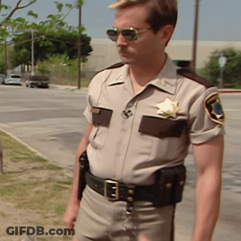A Man In A Sheriff 'S Uniform Has A Star On His Badge GIF