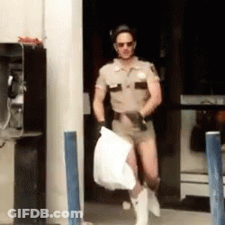 A Man In A Sheriff 'S Uniform Is Carrying A White Bag GIF