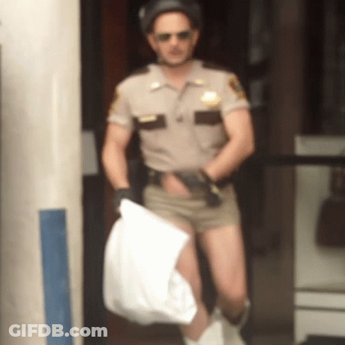 A Man In A Sheriff 'S Uniform Is Holding A Bag GIF