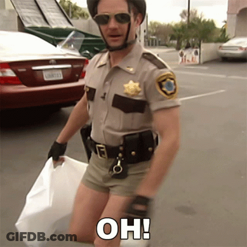 A Man In A Sheriff 'S Uniform Is Kneeling Down And Holding A White Bag With The Words Oh Written On It GIF