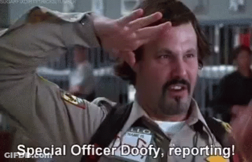 A Man In A Sheriff 'S Uniform Is Saluting With His Hand On His Head . GIF