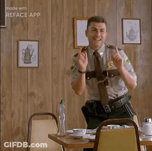 A Man In A Sheriff 'S Uniform Is Sitting At A Table With His Hands In The Air And Says Ah Ha Ha GIF