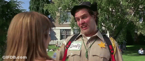 A Man In A Sheriff 'S Uniform Is Talking To A Woman In Front Of A House . GIF