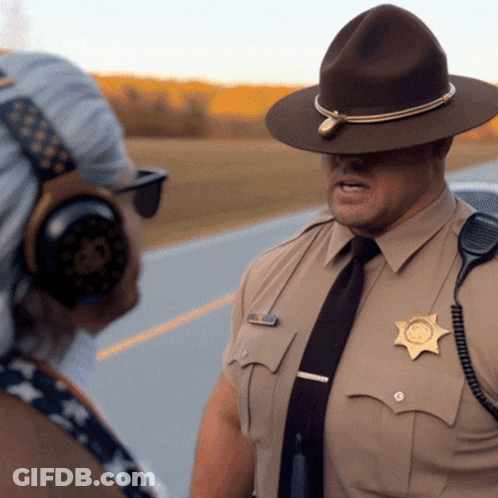A Man In A Sheriff 'S Uniform Is Talking To Another Man GIF
