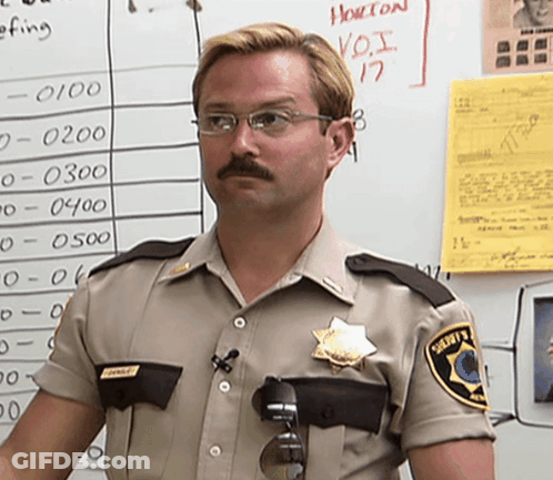 A Man In A Sheriff 'S Uniform Stands In Front Of A White Board With Numbers On It GIF