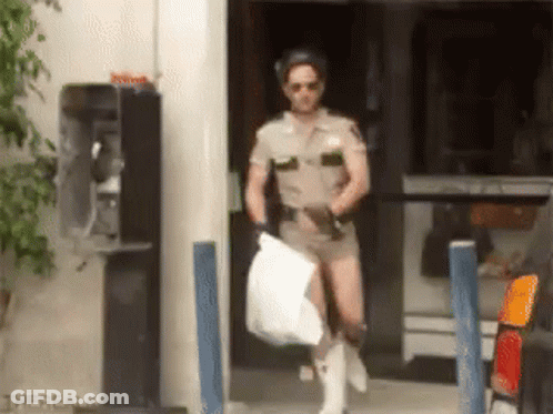 A Man In A Sheriff Uniform Is Carrying A Bag GIF