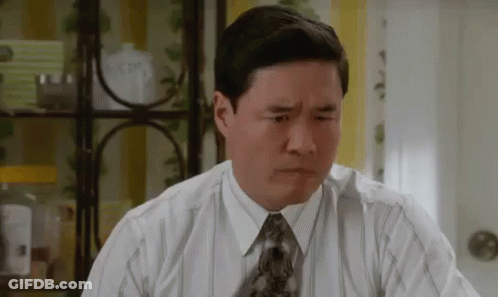 A Man In A Shirt And Tie Is Making A Funny Face . GIF