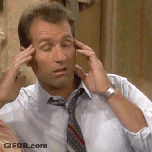 A Man In A Shirt And Tie Is Touching His Forehead GIF