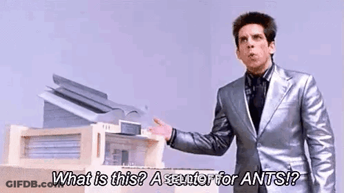 A Man In A Silver Suit Is Standing In Front Of A Printer And Asking What Is This ? A Scuttle For Ants ? GIF