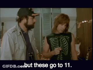 A Man In A Skeleton Shirt Is Talking To Another Man In A Hat ..But These Go To 11 . GIF