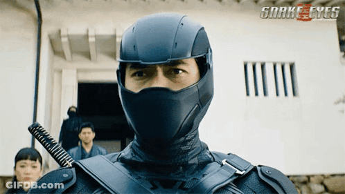 A Man In A Snake Eyes Costume With A Sword In His Hand GIF
