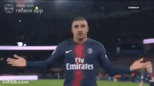 A Man In A Soccer Jersey Is Being Hugged By Another Man GIF