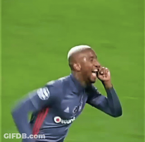 A Man In A Soccer Jersey Is Running On A Field And Giving The Middle Finger . GIF