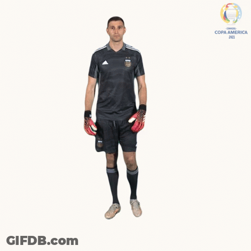 A Man In A Soccer Uniform Is Holding A Pair Of Gloves In Front Of A Copa America Logo GIF