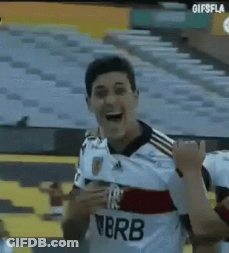 A Man In A Soccer Uniform Is Standing In A Stadium . GIF