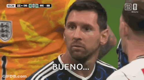 A Man In A Soccer Uniform Is Talking To Another Man And Says Bueno . GIF