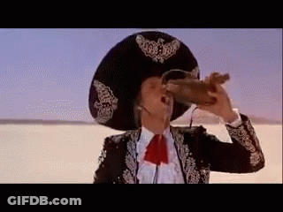 A Man In A Sombrero Is Drinking From A Bottle . GIF