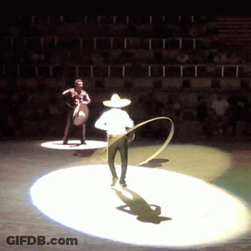 A Man In A Sombrero Stands On A Stage With A Rope GIF
