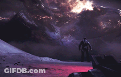 A Man In A Space Suit Is Standing In Front Of A Mountain Range GIF