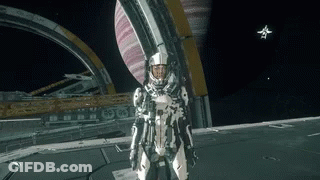 A Man In A Space Suit Is Standing On A Planet GIF