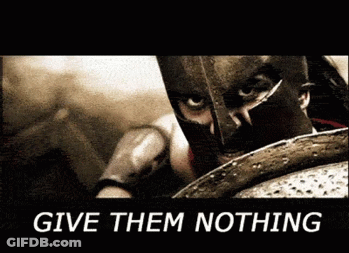 A Man In A Spartan Helmet Is Holding A Shield With The Words " Give Them Nothing " Below Him GIF
