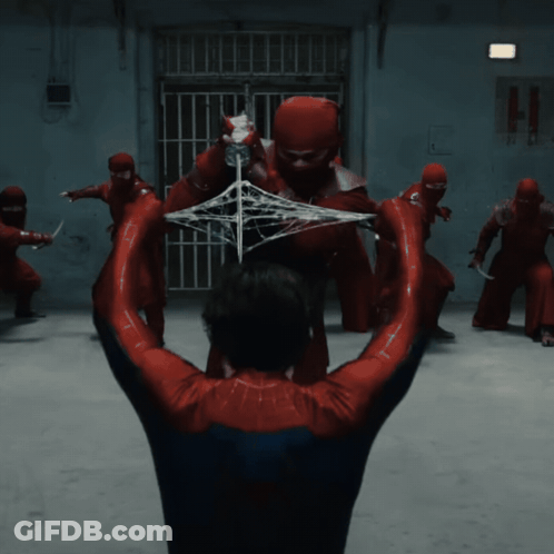 A Man In A Spider-Man Costume Is Being Attacked By A Group Of Ninjas GIF