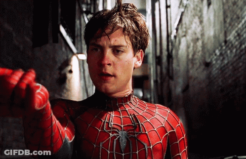 A Man In A Spider-Man Costume Is Pointing At Something GIF