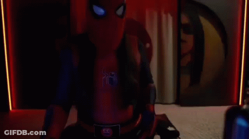 A Man In A Spider-Man Costume Is Sitting In Front Of A Computer In A Room . GIF