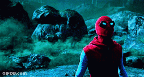 A Man In A Spider Man Costume Is Standing In A Dark Area GIF