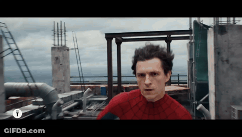 A Man In A Spider Man Costume Is Standing On A Rooftop GIF