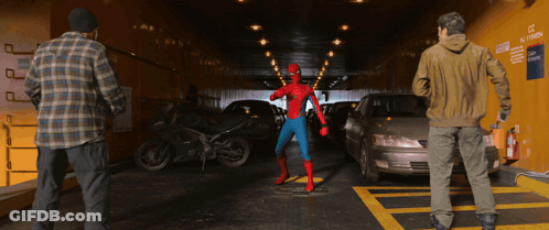 A Man In A Spider Man Costume Stands In A Parking Garage GIF