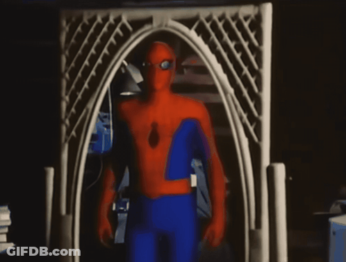 A Man In A Spider Man Costume Stands In Front Of A White Archway GIF