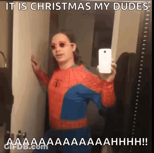 A Man In A Spider Man Costume Taking A Selfie With A Caption That Says It Is Christmas My Dudes GIF