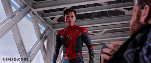 A Man In A Spider Man Suit Talks To Another Man In A Black Jacket GIF