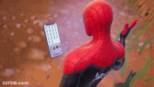A Man In A Spiderman Costume Holds A Cell Phone GIF