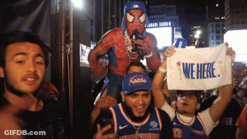 A Man In A Spiderman Costume Is Carrying A Man In A Knicks Jersey On His Shoulders GIF