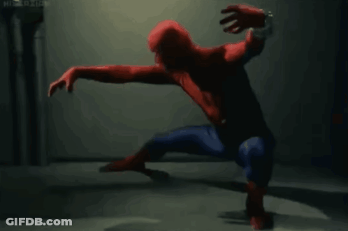 A Man In A Spiderman Costume Is Crawling On The Ground GIF